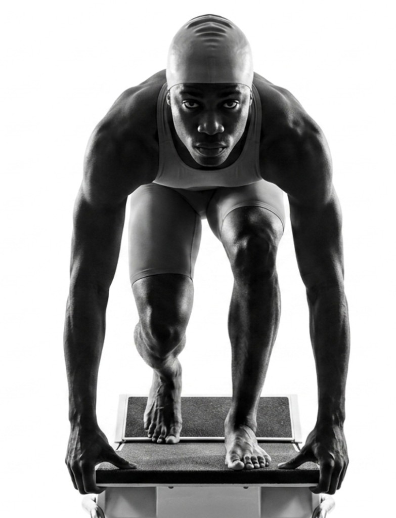 Age-group swimmer on the starting block, ready for the race